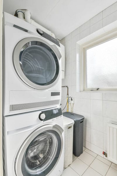 stacked washed and dryer in laundry room